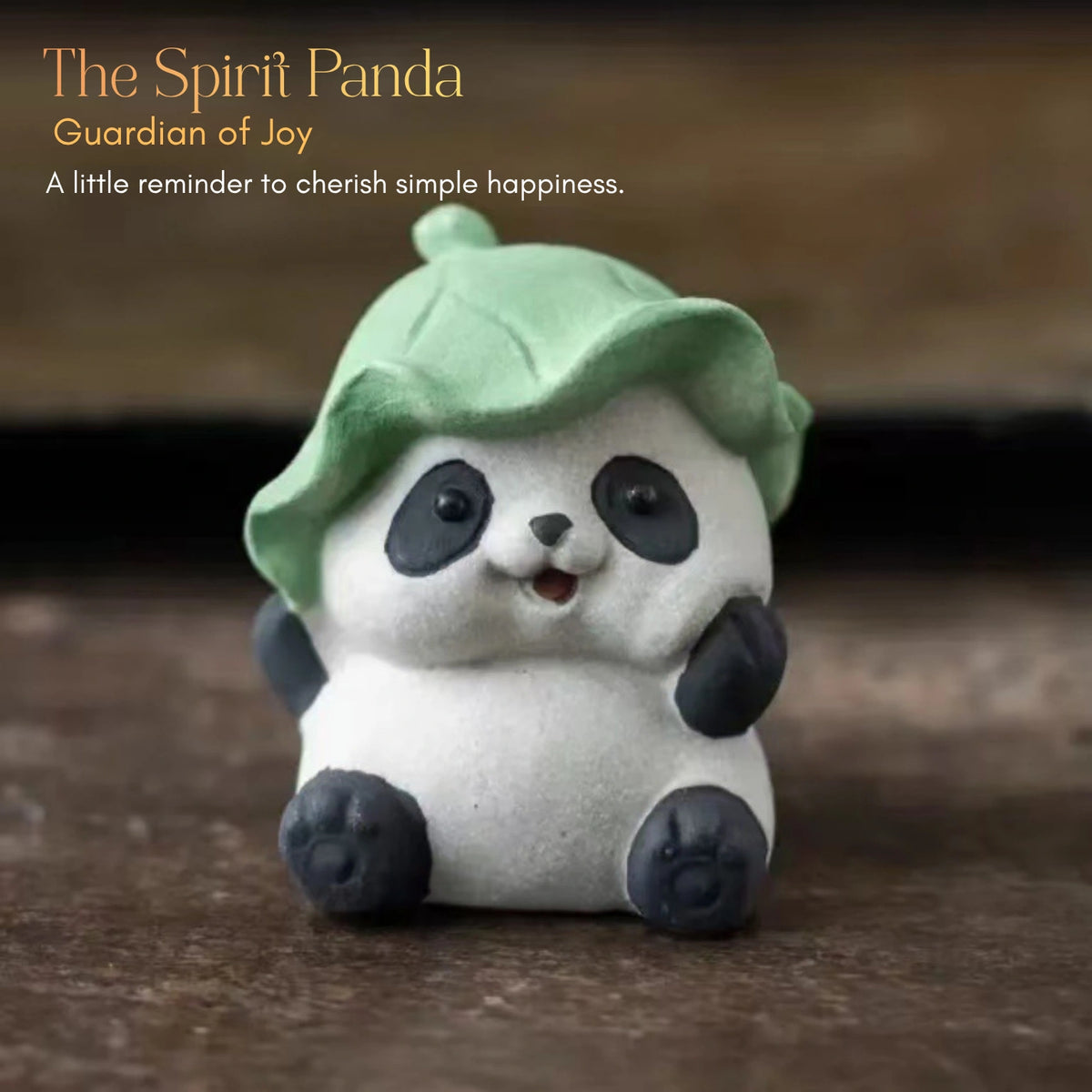 Ceramic Spirit Panda figurine wearing a green leaf hat in a seated pose