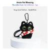 Black plush Yoyo keychain wearing a red-and-white striped knitted scarf with pom-poms