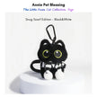 Black plush Yoyo keychain wearing a black-and-white striped knitted scarf with pom-poms