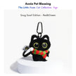 Black plush Yoyo keychain wearing a red-and-green striped knitted scarf with pom-poms