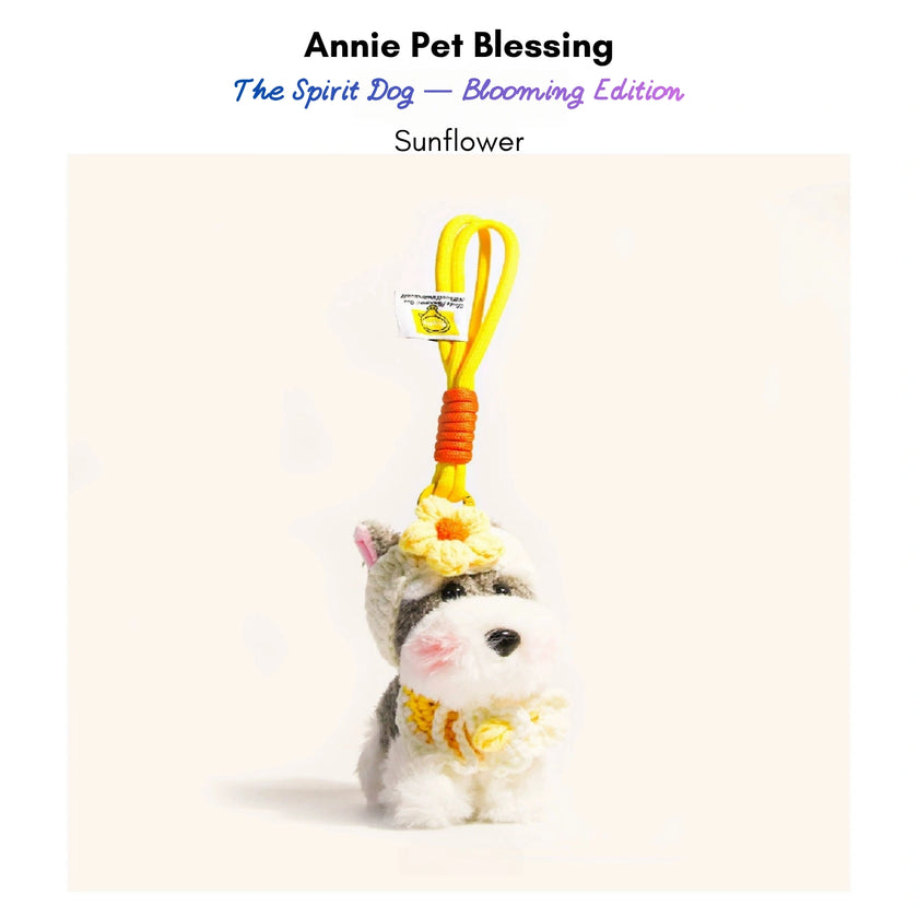Grey-and-white plush Spirit Dog keychain wearing a yellow crocheted flower and collar, Sunflower edition