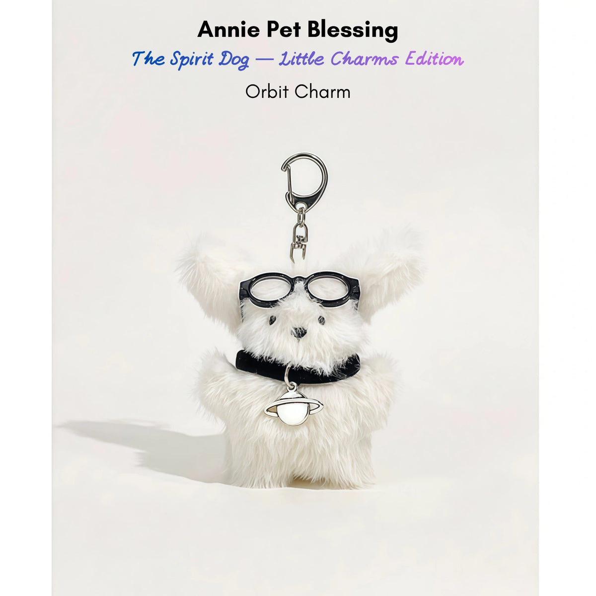 White fluffy plush charm keychain wearing glasses and a collar with a planet-shaped silver charm