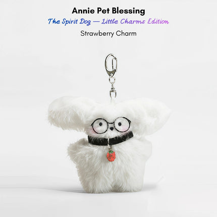 White fluffy plush charm keychain wearing glasses and holding a red strawberry charm