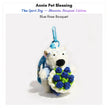 Westie plush keychain wearing a blue sweater and glasses, holding a crocheted blue rose bouquet