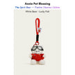 White plush Spirit Bear keychain wearing goggles and a red sweater, holding a Lucky Fish charm