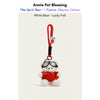 White plush Spirit Bear keychain wearing goggles and a red sweater, holding a Lucky Fish charm