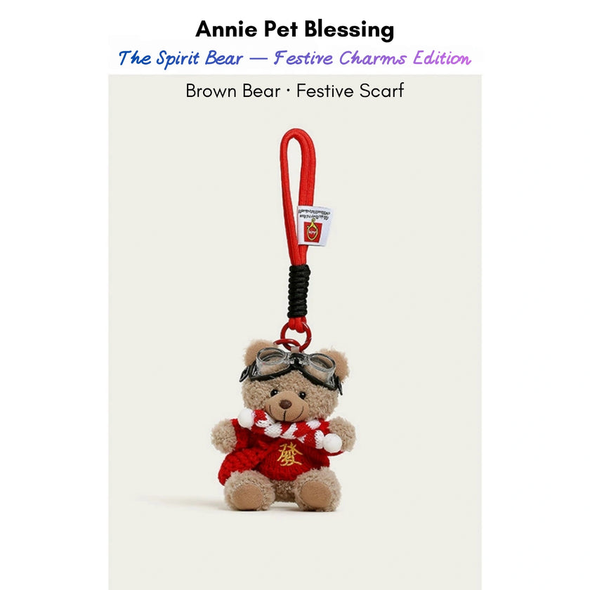 Brown plush Spirit Bear keychain wearing a red scarf with a gold character, Festive Scarf edition