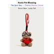 Brown plush Spirit Bear keychain wearing goggles and a red sweater, holding a Lucky Fish charm