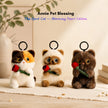 Three plush Spirit Cat keychains, calico, Siamese, and brown, each holding a red velvet rose