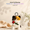 Calico plush Spirit Cat keychain holding a red velvet rose