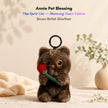 Brown plush Spirit Cat keychain holding a red velvet rose