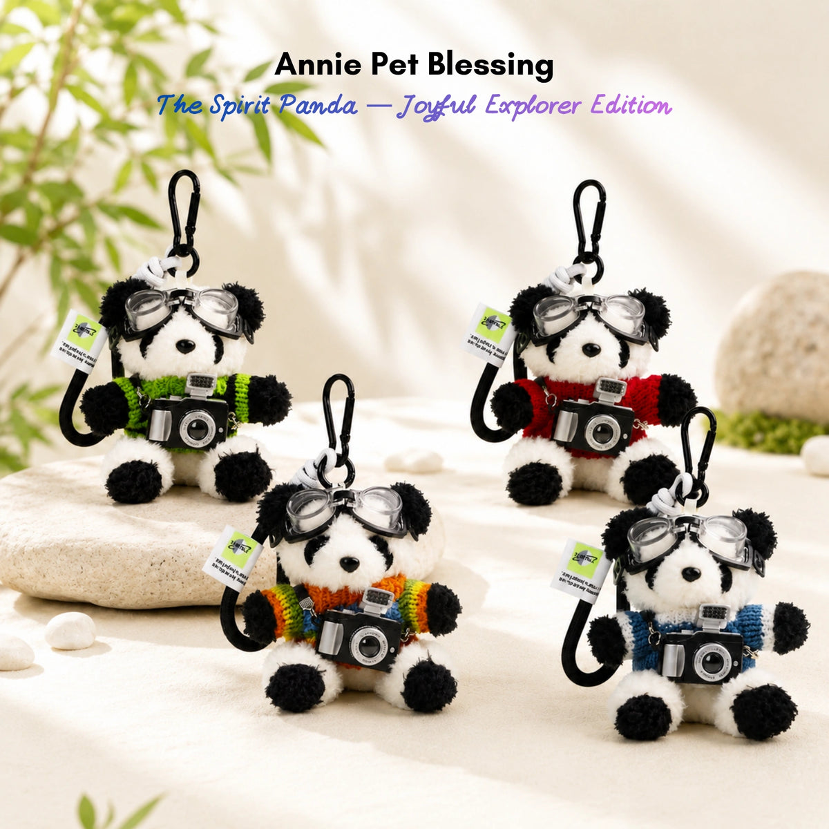 Four plush Spirit Panda keychains wearing goggles and knit sweaters, each holding a toy camera
