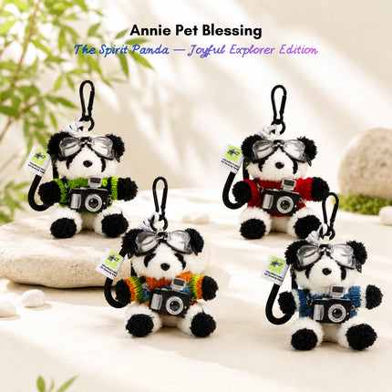 Four plush Spirit Panda keychains wearing goggles and knit sweaters, each holding a toy camera