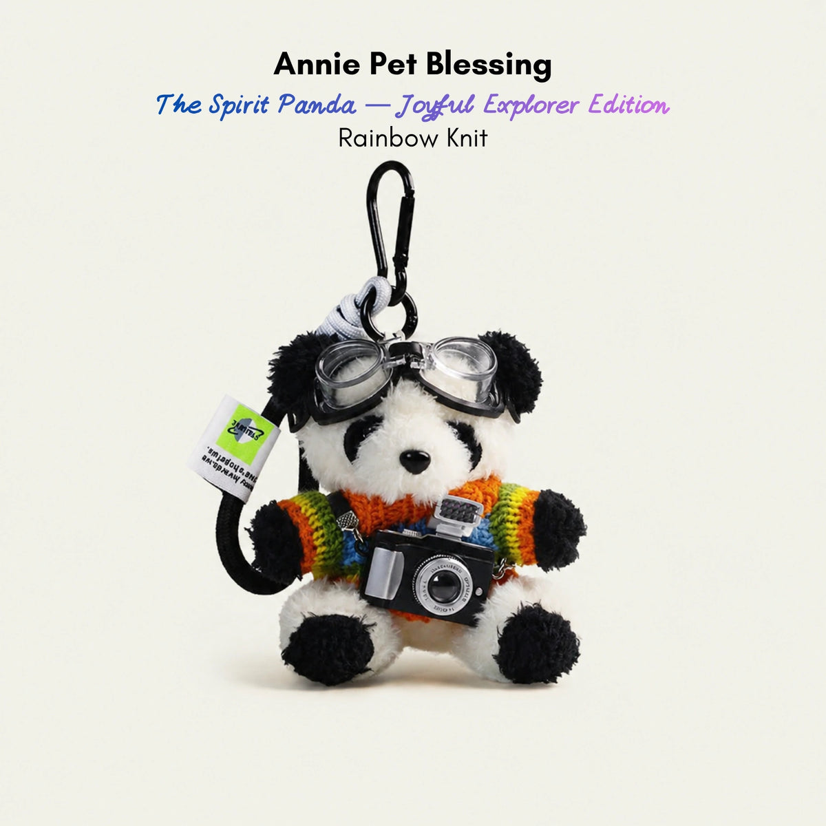 Plush Spirit Panda keychain wearing goggles and a rainbow-striped sweater, holding a toy camera