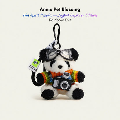 Plush Spirit Panda keychain wearing goggles and a rainbow-striped sweater, holding a toy camera