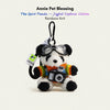 Plush Spirit Panda keychain wearing goggles and a rainbow-striped sweater, holding a toy camera