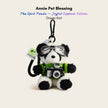 Plush Spirit Panda keychain wearing goggles and a green knit sweater, holding a toy camera