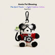 Plush Spirit Panda keychain wearing goggles and a red knit sweater, holding a toy camera