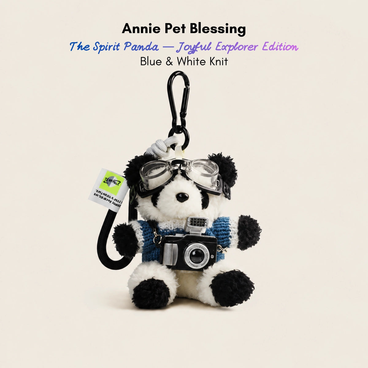 Plush Spirit Panda keychain wearing goggles and a blue-and-white striped sweater, holding a toy camera