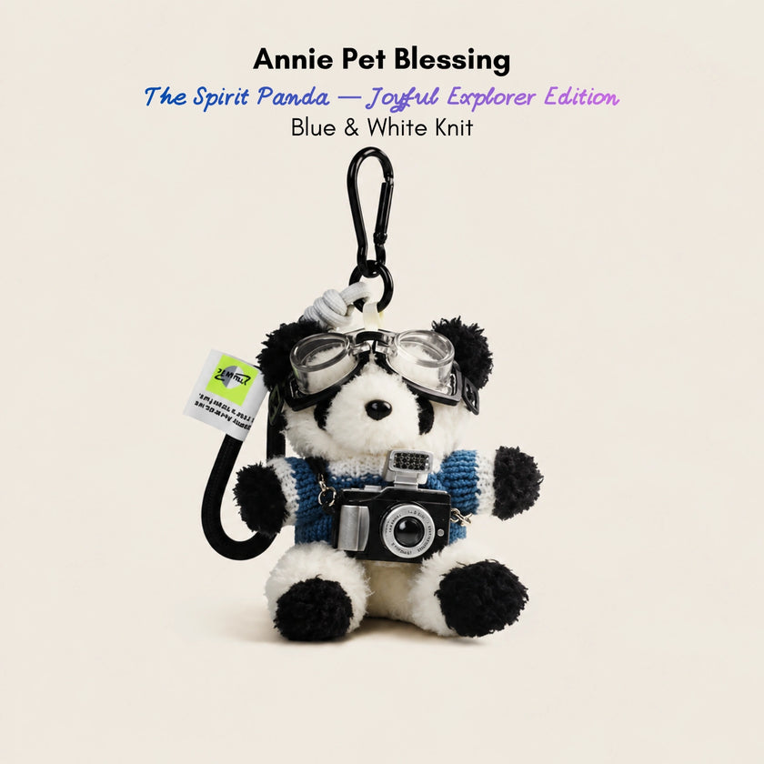 Plush Spirit Panda keychain wearing goggles and a blue-and-white striped sweater, holding a toy camera