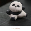 Close-up of a textured ceramic Spirit Panda figurine in a punch pose with one paw raised