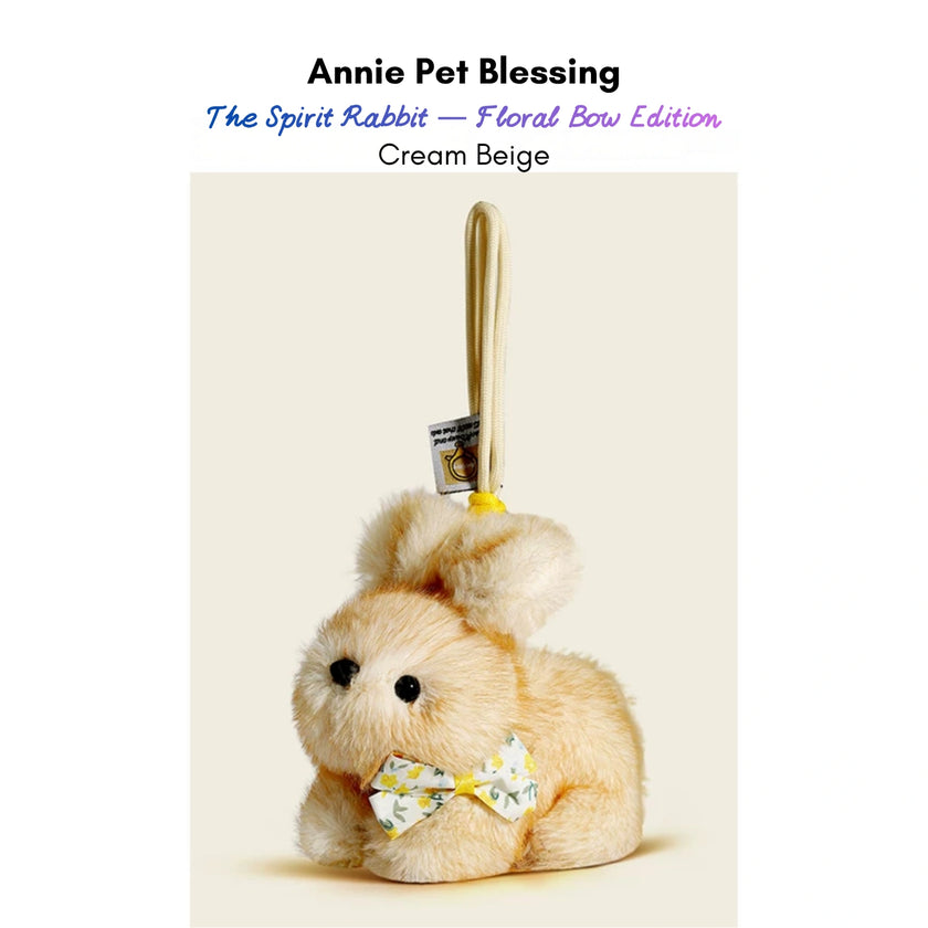 Cream plush Spirit Rabbit keychain wearing a yellow floral-print bow