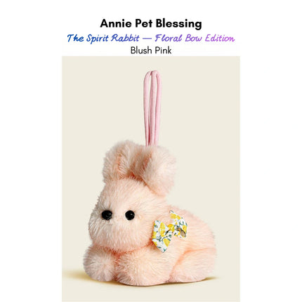 Pink plush Spirit Rabbit keychain wearing a floral-print bow