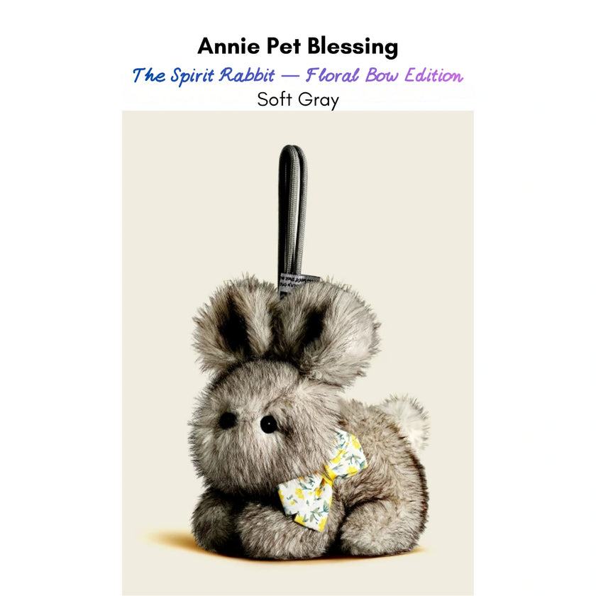 Gray plush Spirit Rabbit keychain wearing a yellow floral-print bow