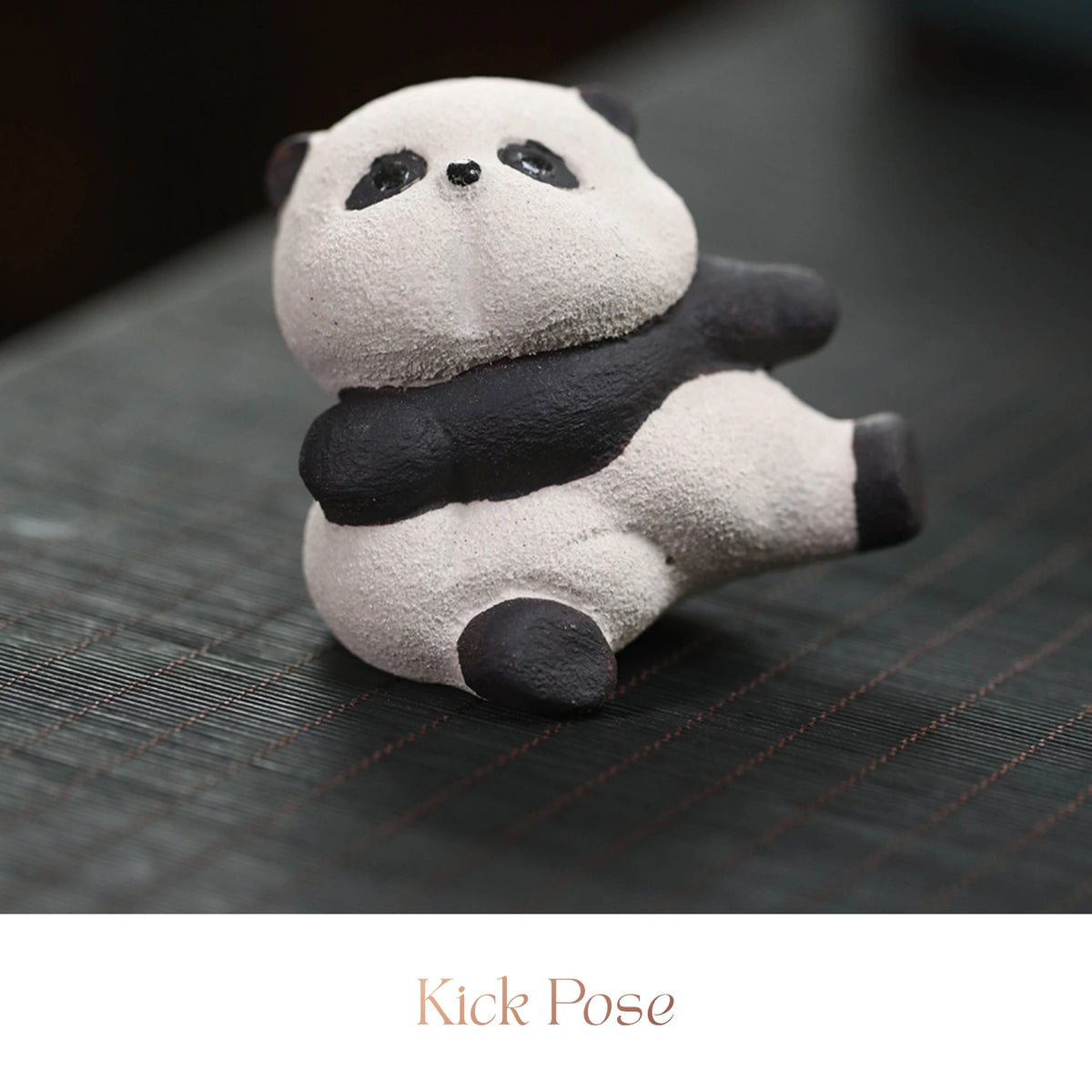 Close-up of a textured ceramic Spirit Panda figurine in a reclining kick pose