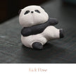 Close-up of a textured ceramic Spirit Panda figurine in a reclining kick pose