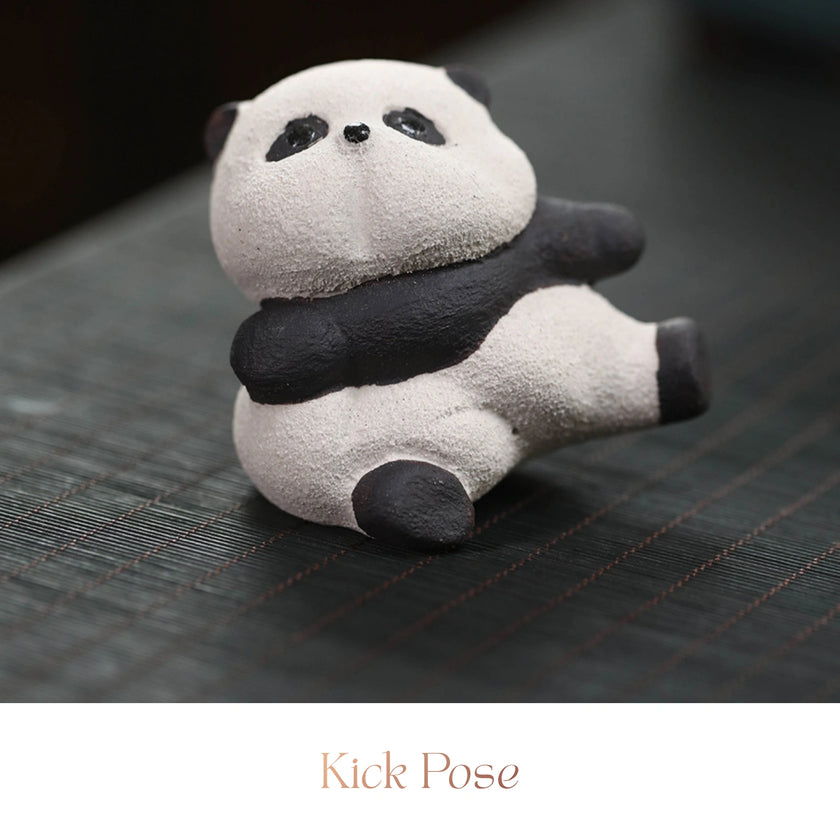 Close-up of a textured ceramic Spirit Panda figurine in a reclining kick pose