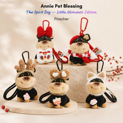 Five black plush Spirit Dog keychains, each wearing a different accessory: bow, beret, antlers, or ears