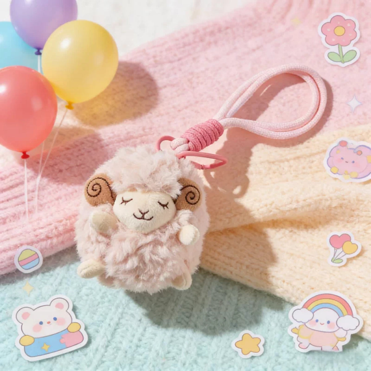 Pink plush Spirit Sheep keychain close-up on a pastel blanket with stickers