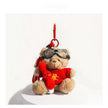 Tan plush Spirit Bear keychain wearing goggles, holding a small red bunny charm