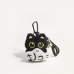 Close-up of a black plush Yoyo keychain holding the crying-face Cloudy Fish charm