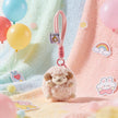 Pink plush Spirit Sheep keychain on a pastel blanket with balloons and stickers
