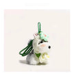 Close-up of a grey-and-white plush Spirit Dog keychain wearing a mint-green crocheted flower headpiece