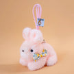 Pink plush Spirit Rabbit keychain wearing a yellow floral-print bow
