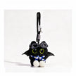 Close-up of a black plush bat-winged Yoyo keychain wearing goggles and a blue-and-white striped scarf