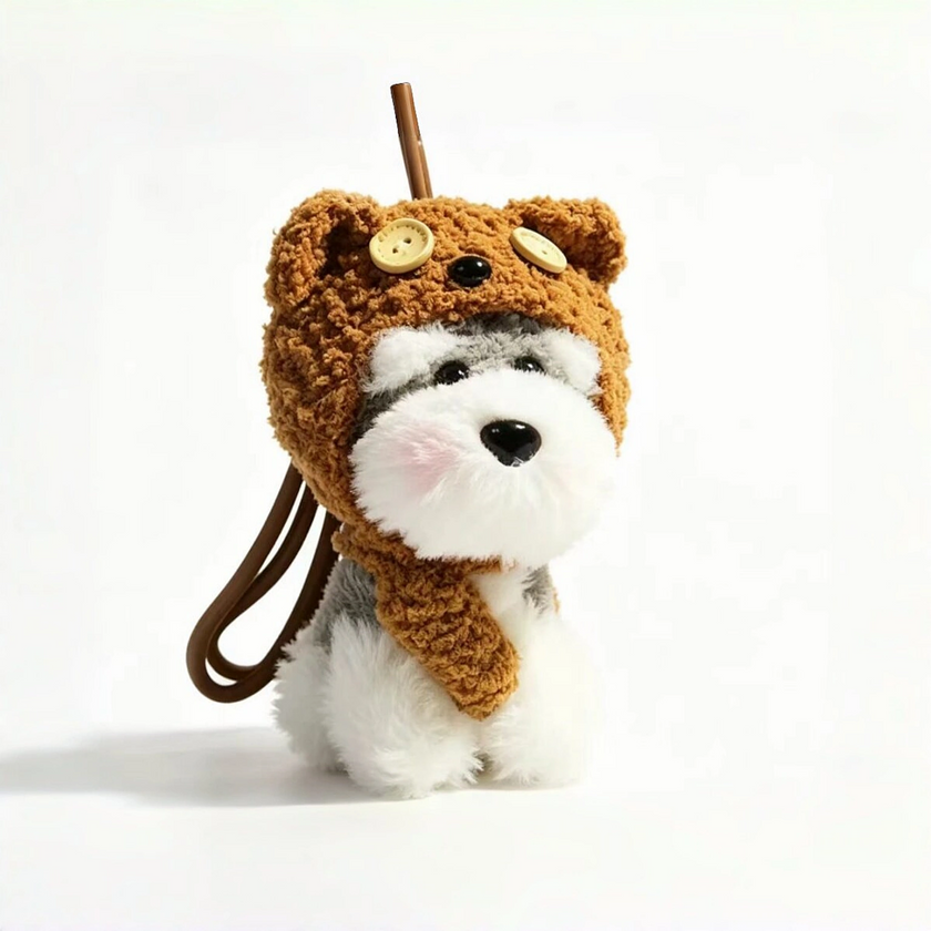 Close-up of a grey-and-white plush Spirit Dog keychain wearing a brown teddy bear hood