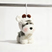 Grey-and-white plush Spirit Dog keychain wearing a white knitted hood with brown pom-pom ears