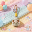 Sage green plush Spirit Sheep keychain on a pastel blanket with balloons and stickers