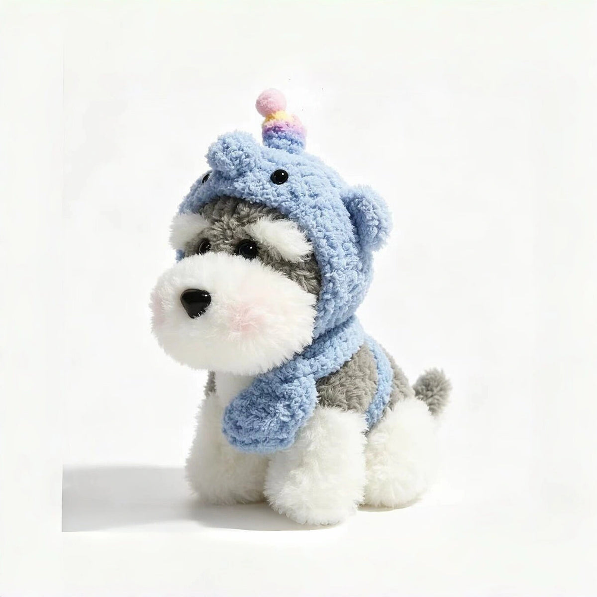 Grey-and-white plush Spirit Dog keychain wearing a light blue knitted hood with a pastel unicorn horn