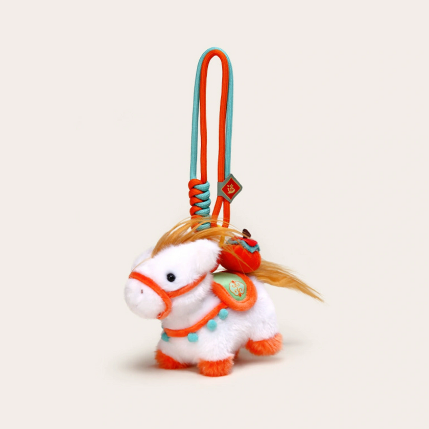 Four plush Heavenly Steed horse keychains displayed on white pedestal blocks of varying heights