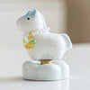 Close-up of a ceramic Heavenly Steed unicorn figurine in pale blue with a pearl necklace and green-gold butterfly charm